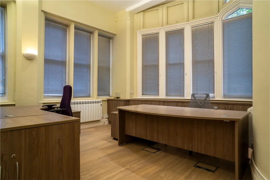 Office 01 — desk beneath the arched window